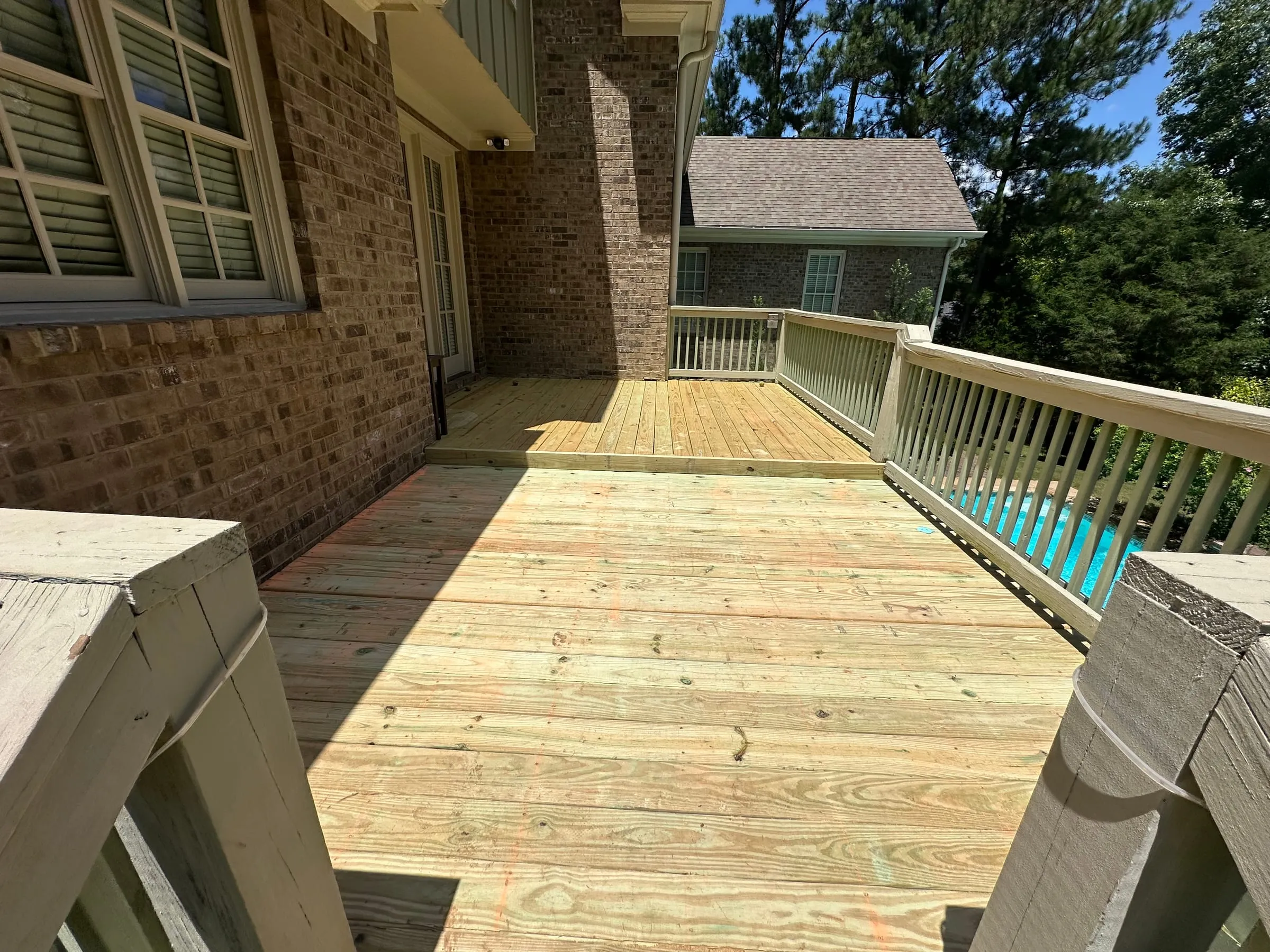Pressure-treated poolside deck built by A. Webb Construction